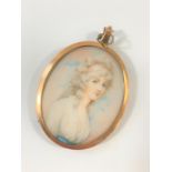 A miniature painting of a Lady in a 9ct gold frame
