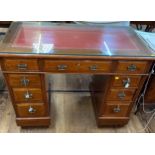 An Mahogany Kneehole Desk. 20th century. With leather inset top under glass. Fitted with a single
