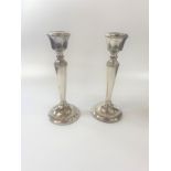 A pair of silver candlesticks, some 8 inch tall on round beaded foot