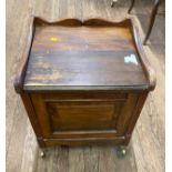 A Victorian Pine Commode. The hinged lid opening to reveal handles. Twin side grips and with a