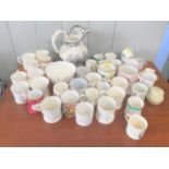 A Wedgewood transfer printed jug 26cm and a collection of souvenir mugs