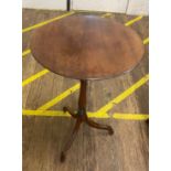 An Antique Mahogany Tripod Table. With a circular top and down swept supports. 73cm x 44 cm diameter