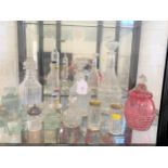 Three glass decanters, phials, thermometer, bottles and cranberry jar and cover