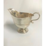 A George III Silver sauce boat. Apparently unmarked. Large repair to lip. 9.5cm x 12.5cm. 154 grams