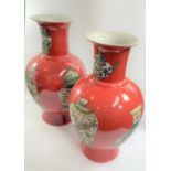 A Pair of Chinese Vases. 20th Century. Each decorated with vases on a red ground. Six character mark