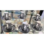 A Thistledown porcelain set of six coffee cans with saucers decorated with Seahorse on matt black