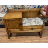 An Oak Telephone Seat. 20th century. With upholstered loose seat. 78cm x 98cm x44cm