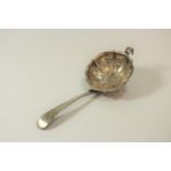 An Antique Silver Coloured Metal Tea strainer. Apparently unmarked. 16cm long. 40grams. 1.28oz.