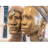 An African Bronze of a female head. Gilt bronze patination.