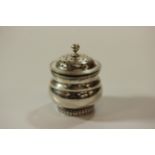 A George III Sterling Silver Pepperette. London 1817. makers mark illegible. Of squat baluster form.