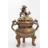 A late 19th century brass koro having two handles in the form of lions and a lion knob. The koro