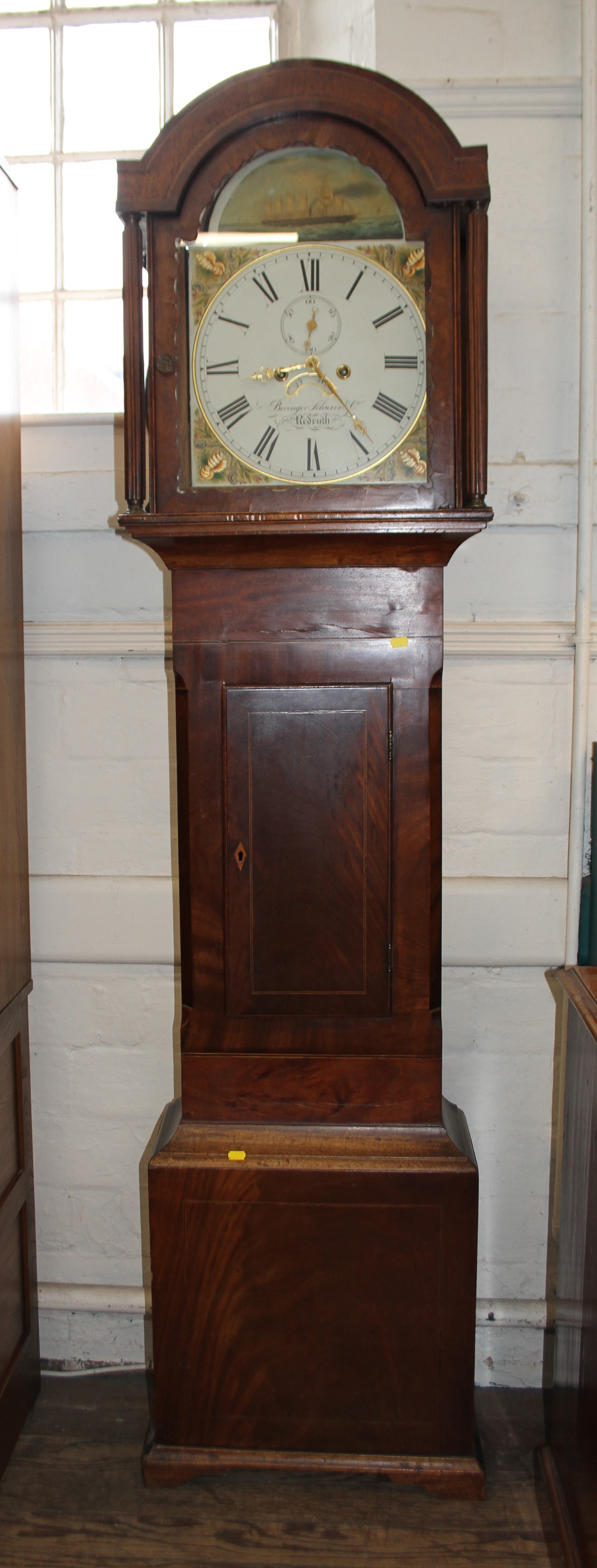 A Cornish long case clock. Mid 19th Century. Mahogany case. 8 day. Painted arch dial with 12" main