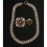 A Scottish Silver Brooch, Set With A Banded Agate Stone, A Black Enamel Memorial Brooch, and An