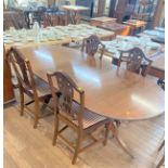 A Reproduction Mahogany Dining table together with four chairs.