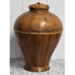 A Chinese wooden urn with carved lid. 41cm tall