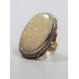 A Large Opal Ring Set in 18ct Gold and Diamonds. Size of Opal 33mm x 22mm