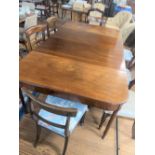 A Late George III Mahogany Dining table and seven Chairs. Circa 1810. Complete with two extra