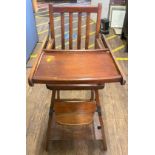 A Childs Stained Wood Folding High Chair. Early 20th century.