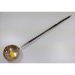 A George III silver toddy ladle. London 1741. With whale bone handle.