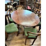 An oak dining table together with 6 Victorian balloon back chairs