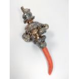 A baby's silver rattle with coral handle by George Unite