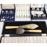 A cased set of six plated teaspoons with nut finials, a cased set of six plated napkin rings, and