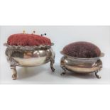 Two silver plated pin cushions on four feet.