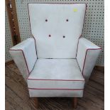 small cream chair, button back with red piping on cushions and arms