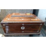 A Victorian sewing box with some Mother of Pearl stringing, sat on bun feet.