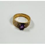 A ladies 9ct gold bark finish set with an amethyst size O