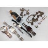 A bag of men's and ladies' fashion watches, two silver charm bracelets, and silver rings.