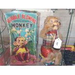 An Alps Bubble Blowing Monkey in original lidded box 26.5cm, and a miniature ceramic tea set.