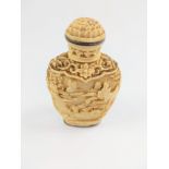 A 19th century Chinese carving of a bone snuff bottle.
