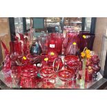 A selection of red glass, mostly small bowls and an amethyst bottle vase.