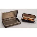 A 900 silver case with engine turn decoration and an amber cigarette holder in case.