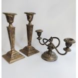 A pair of Adam style candlesticks and a two branch candelabra.