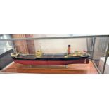A Builders or Boardroom Model of a Cargo Ship. First half of the 20th century. In a glass case.