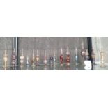 Sixteen tinted and clear glass scent bottles (16)