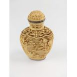 A 19th century Chinese bone carved snuff bottle, highly decorated depicting a village scene.