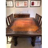 A Good Victorian Carved Oak Table together with 11 dining chairs with rattan backs. The table with