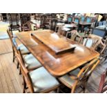 A Reproduction Yew Wood Georgian Style Dining table and 8 chairs. 20th century. The table with two