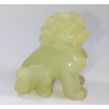 A small jade carving of a lion.