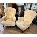 A pair of button back upholstered armchairs. early 20th century.