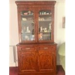 A Good Victorian Mahogany Bookcase. Circa 1850. With a moulded cornice above a pair of glazed