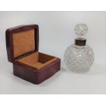 A leather trinket box a silver panel to lid, together with a perfume bottle with silver collar.