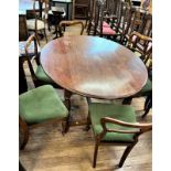 An oak dining table together with 6 Victorian balloon back chairs