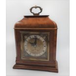 A small mantle piece wooden clock