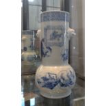 A Chinese blue and white cylindrical bottle vase with mask head handles 22.5cm. 20th century.