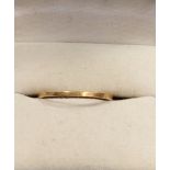 A very worn 18ct gold wedding ring.