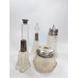 Five silver mounted glass toilet bottles.